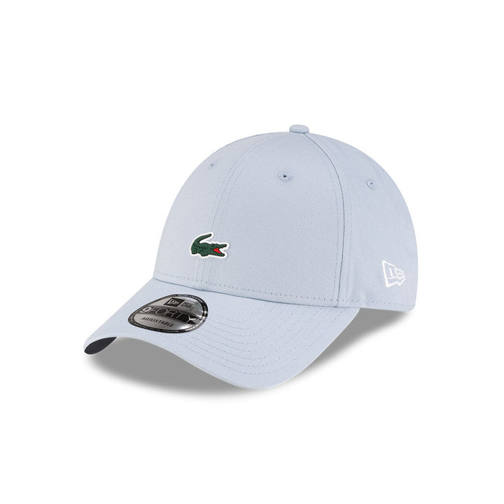 Front left view of New Era x Lacoste 9FORTY Core Light Blue Adjustable Cap highlighting the classic New Era flag logo