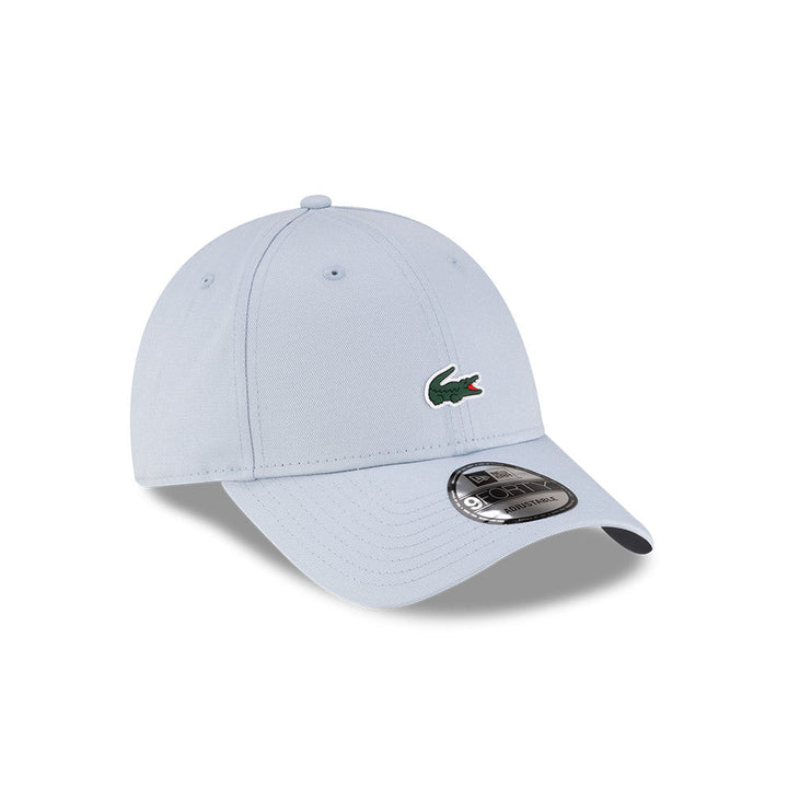 Front right view of New Era x Lacoste 9FORTY Core Light Blue Adjustable Cap displaying the classic crown.