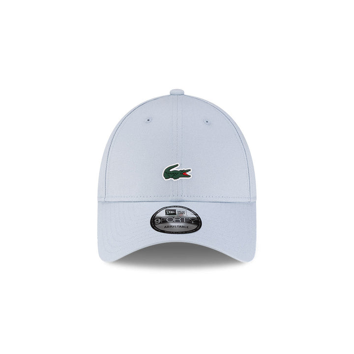 Front view of New Era x Lacoste 9FORTY Core Light Blue Adjustable Cap highlighting the centered crocodile logo
