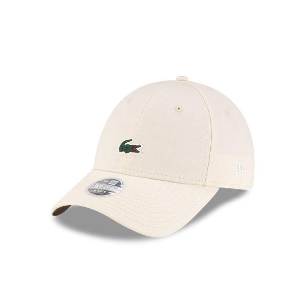 Front left view of New Era x Lacoste 9FORTY Women Core Light Beige Adjustable Cap highlighting the classic New Era flag logo