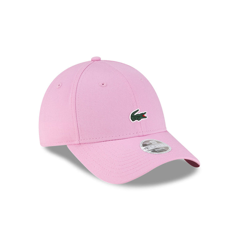 Front right view of New Era x Lacoste 9FORTY Women Core Pastel Pink Adjustable Cap displaying the classic crown.