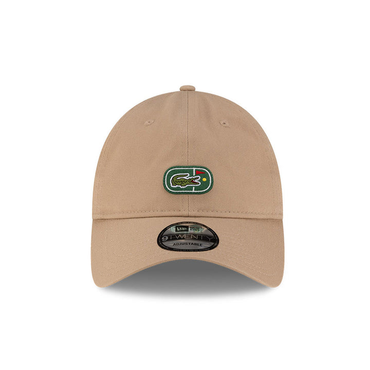 Front view of New Era x Lacoste 9TWENTY Flag Beige Adjustable Cap highlighting the centered iconic crocodile logo.