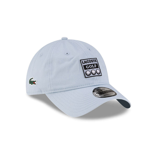 Front right view of New Era x Lacoste 9TWENTY Golf Ball Pastel Blue Adjustable Cap highlighting the side crocodile logo