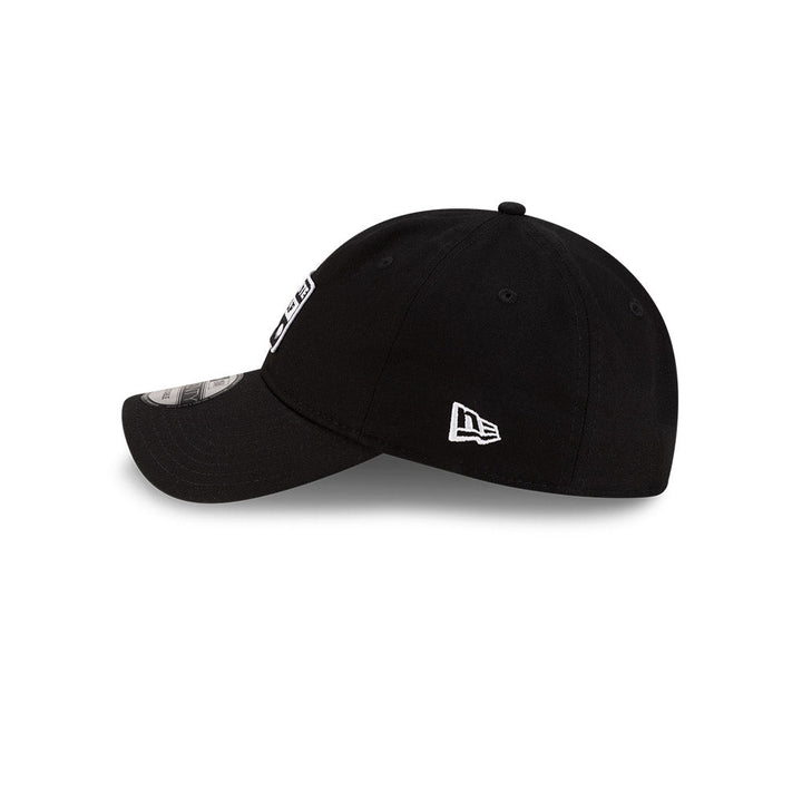eft side profile view of New Era x Lacoste 9TWENTY Golf Ball Black Adjustable Cap featuring stitched New Era flag logo.